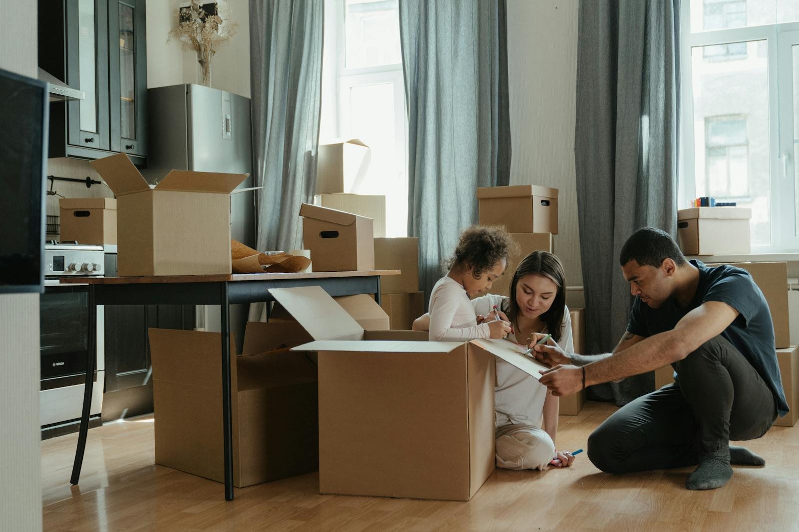 A family packing cardboard boxes together at home