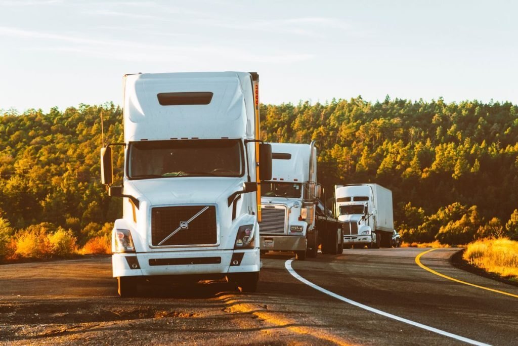 Line-haul trucks on an open highway at golden hour