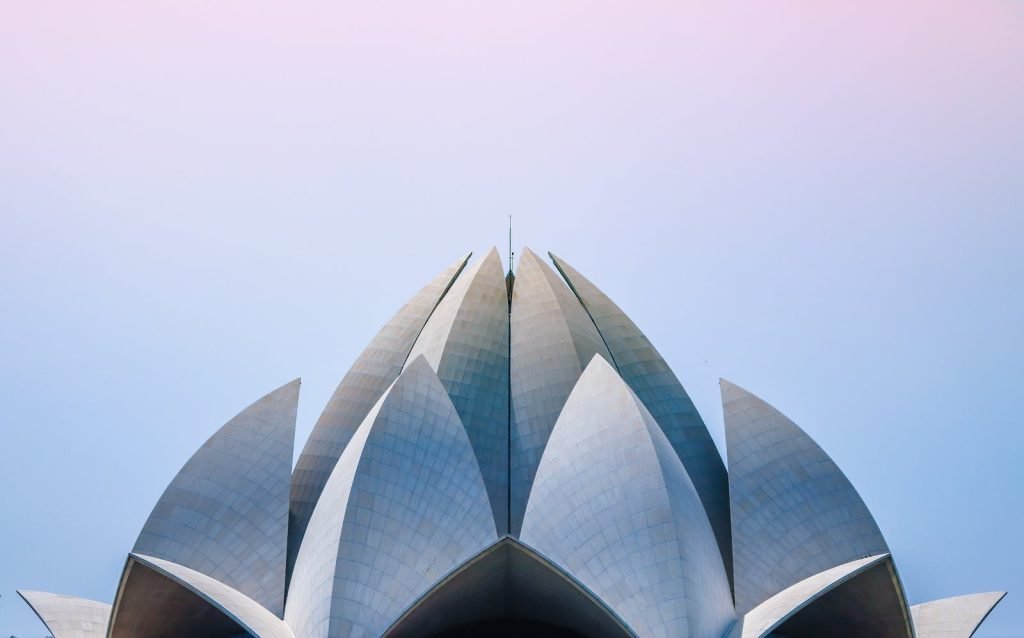 The Lotus Temple in Delhi, its white petals against a pale sky