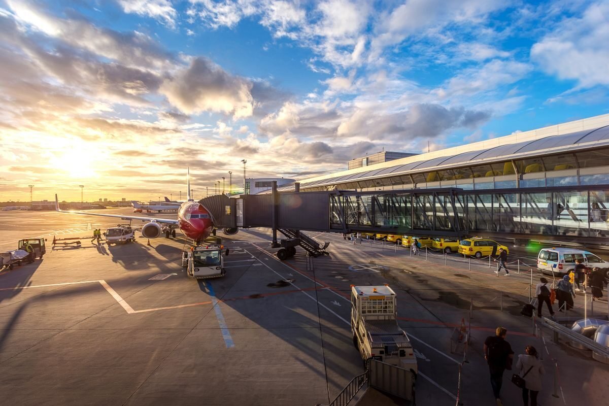 Aircraft on the apron at sunrise being loaded by ground crew