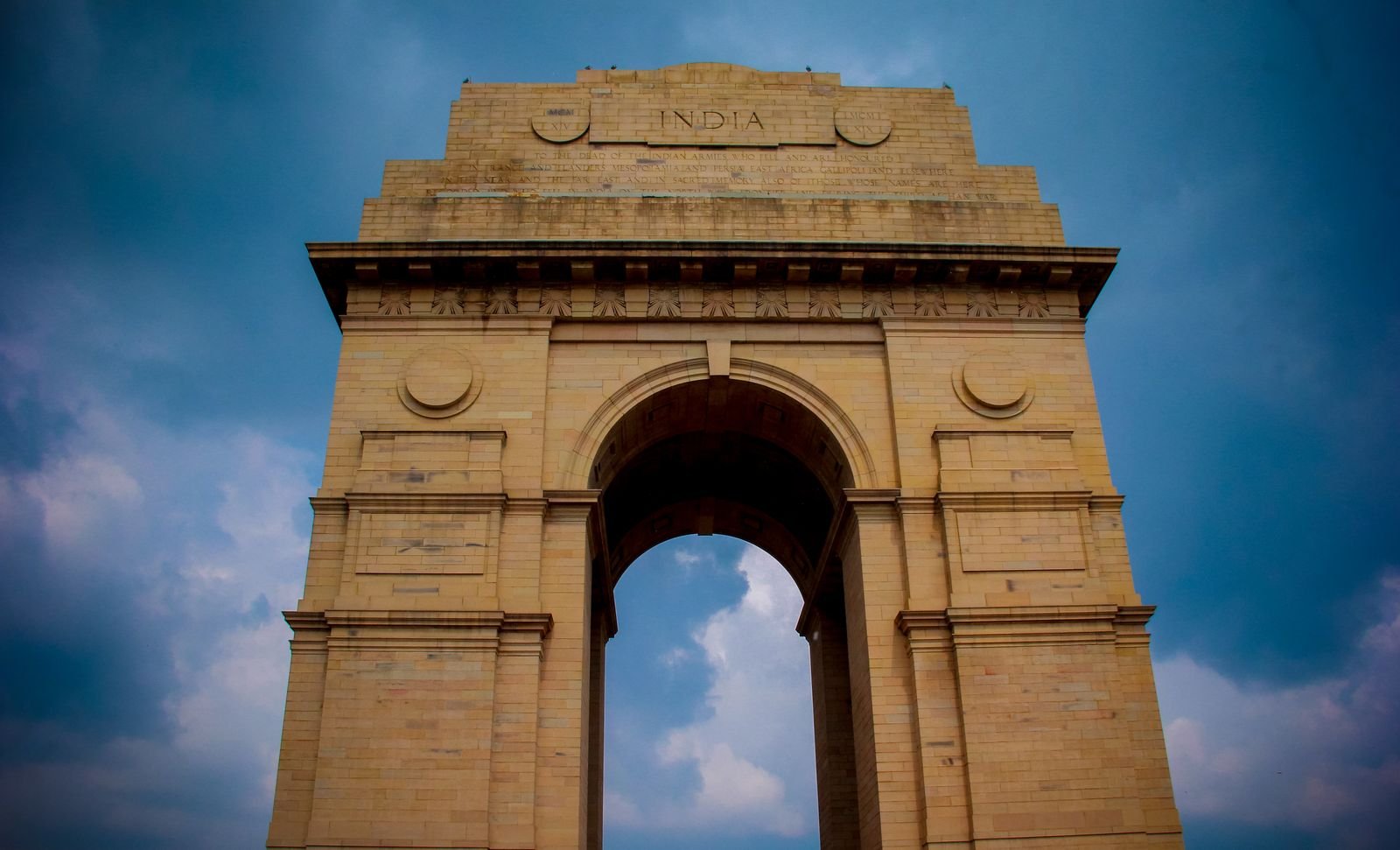 India Gate in New Delhi against a cloudy sky