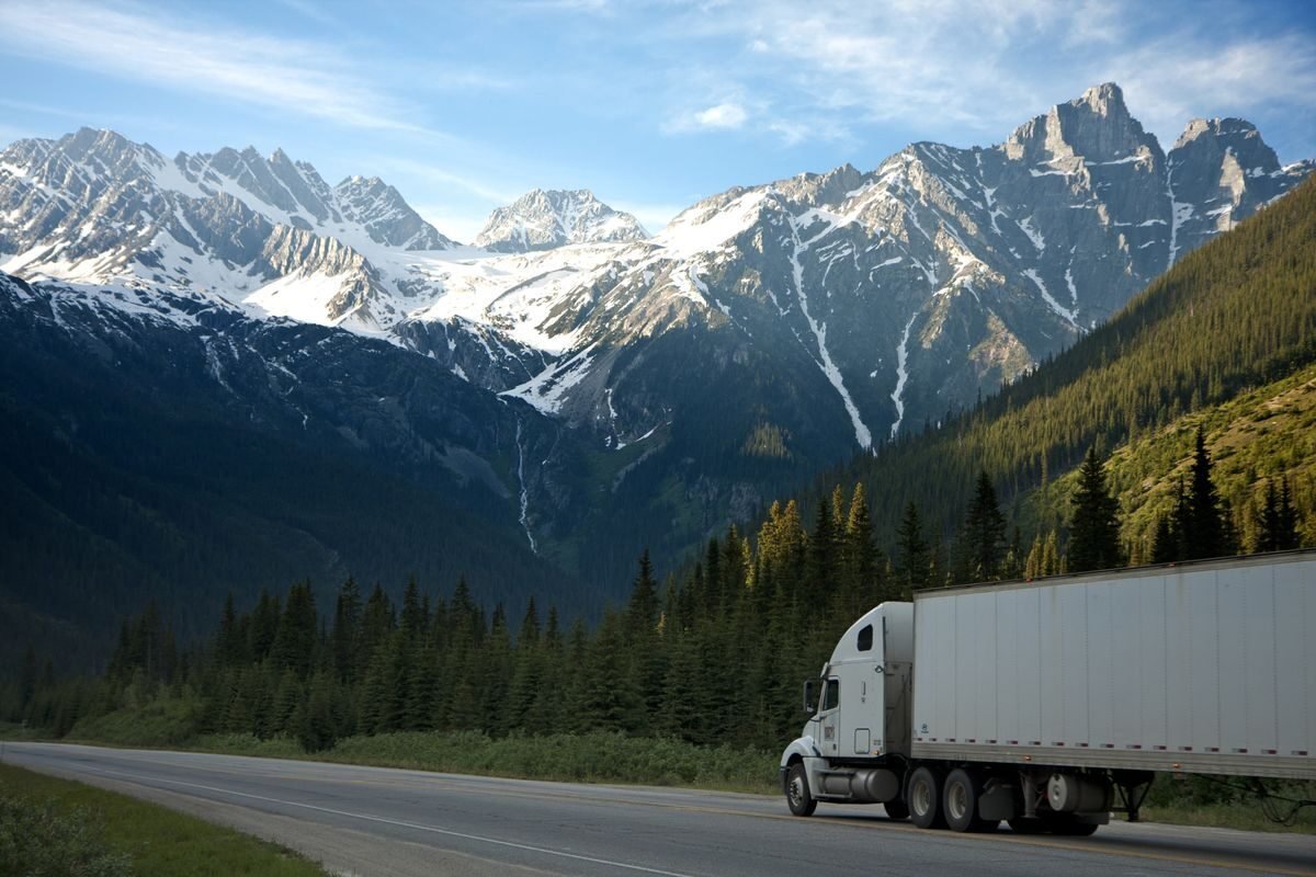 Articulated truck on an open highway through mountains