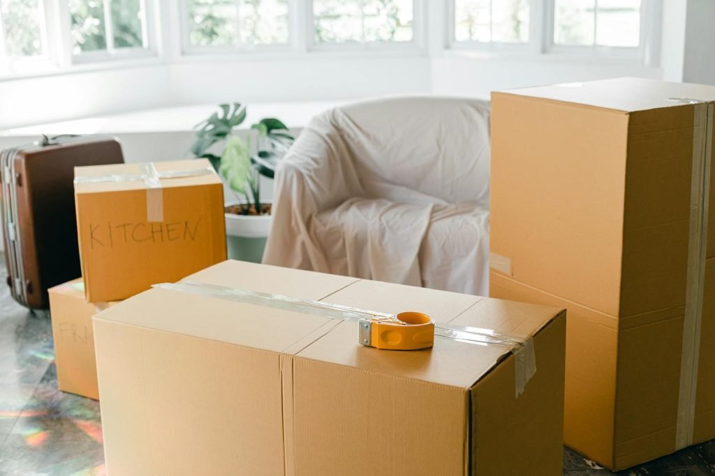 Family unpacking moving boxes in new home abroad after relocation from India